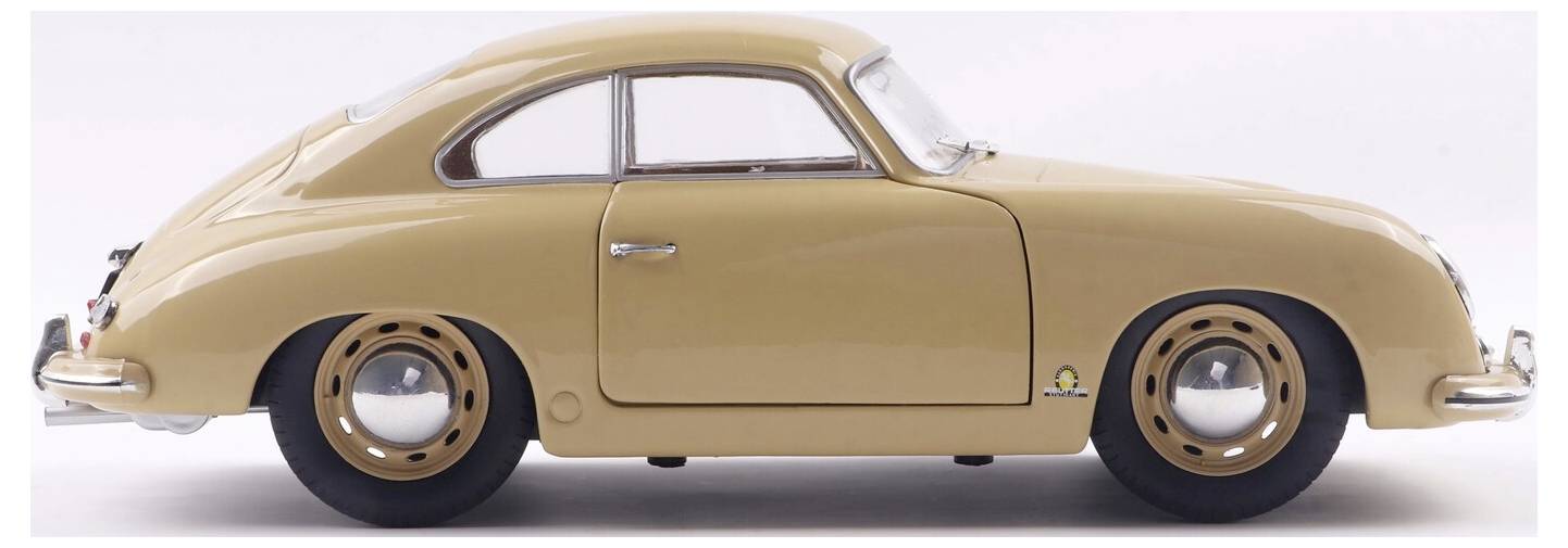 Ein klassisches beiges Oldtimer in Seitenansicht, das sein elegantes, abgerundetes Design und die charakteristischen runden Radkappen hervorhebt.