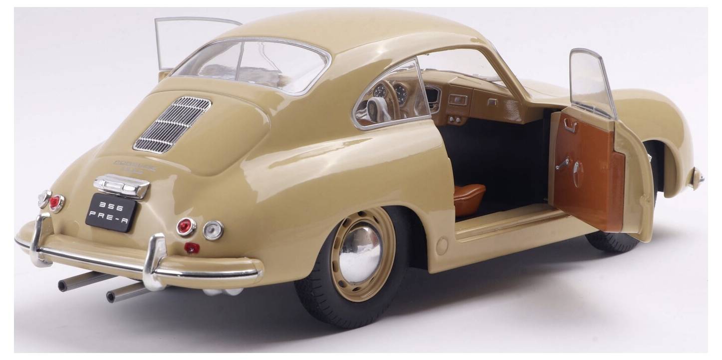 Ein Oldtimer in Beige mit offenen Türen, der sein Interieur präsentiert. Das Fahrzeug verfügt über ein klassisches Design mit abgerundeten Kanten und Chrom-Details.