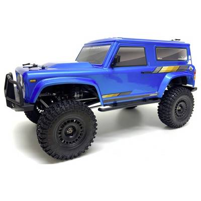 Ein blauer ferngesteuerter Geländewagen mit einer kastenförmigen Konstruktion, großen Reifen und gelben Streifen an der Seite.