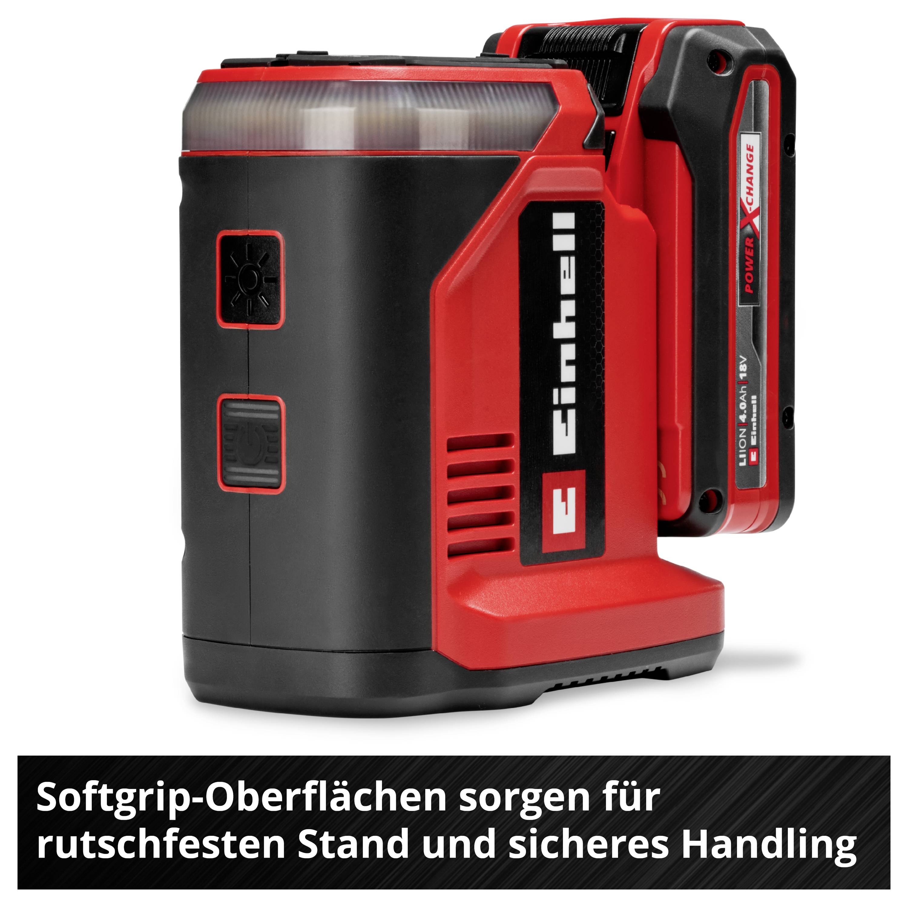 Einhell Akku-Lampe mit Softgrip-Oberfläche für stabilen Stand und sicheres Handling, im Hintergrund Akku mit Ladeanzeige.