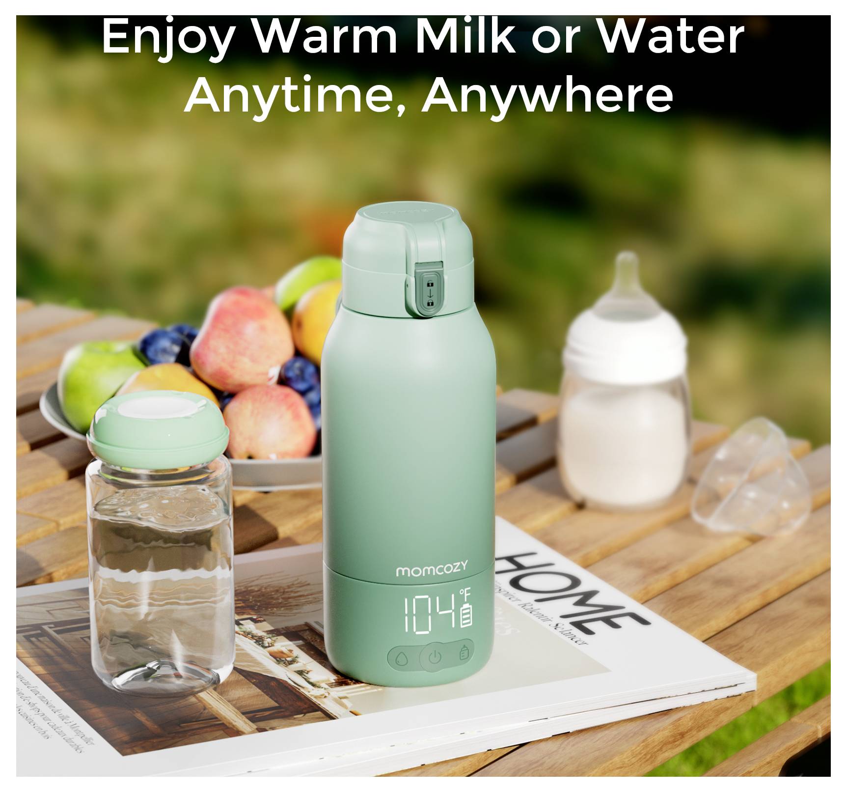 Ein grüner tragbarer Flaschenwärmer auf einem Tisch mit einer digitalen Anzeige, die 40°C anzeigt, umgeben von einer Wasserflasche und einer Babyflasche.