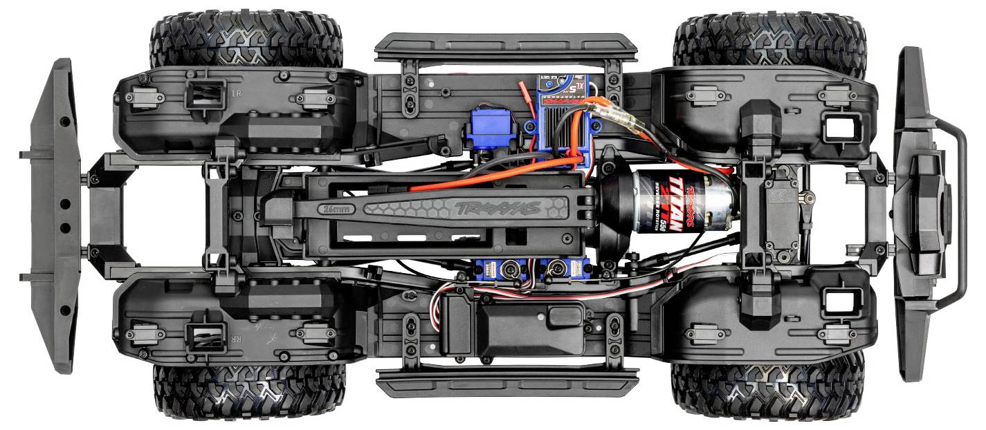 Draufsicht eines ferngesteuerten Truck-Chassis, das Federung, Batteriefach, Verkabelung und Motorkomponenten zeigt.