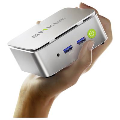 Ein kleines, silbernes Mini-PC-Gerät mit USB-Anschlüssen und einem Stromschalter wird in einer Hand gehalten. Der Markenname ist auf der Oberseite sichtbar.