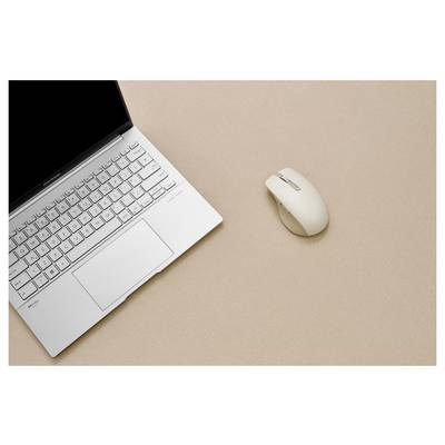 Ein silberner Laptop mit sichtbarer Tastatur und Trackpad ist auf einer beigen Oberfläche geöffnet, daneben liegt eine kabellose Maus.