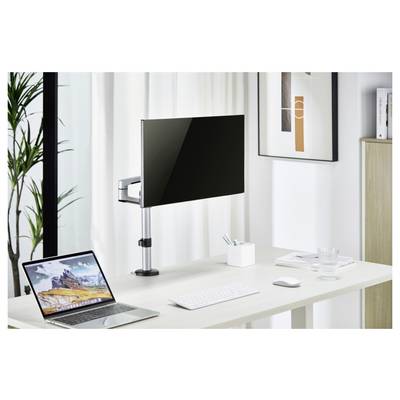 Ein minimalistisches Bürotisch-Setup mit einem Laptop, einem angebrachten Monitor, einer Tastatur, einer Maus und einer kleinen Pflanze, angesiedelt in einem hellen, zeitgenössischen Raum.
