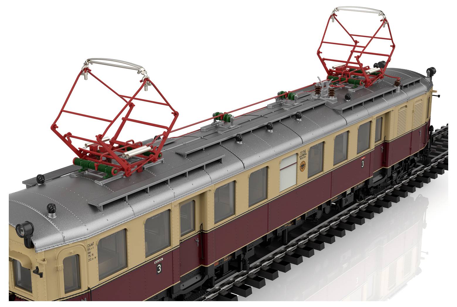 Ein Modell eines modernen weißen Zuges mit einem roten Streifen auf einem Gleis, mit einem abnehmbaren Dach, vor einem unscharfen Stadtbildhintergrund.