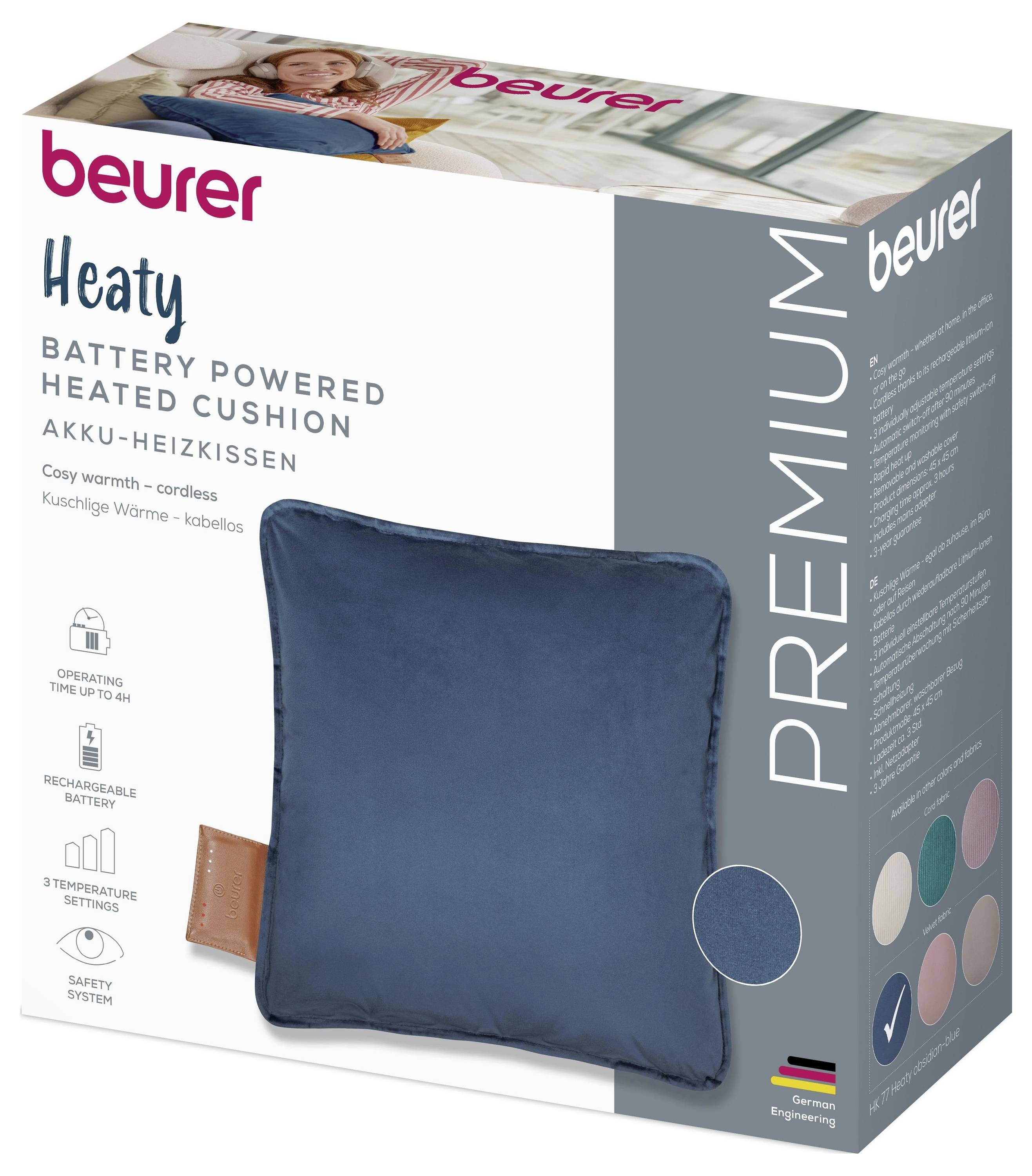 „Beurer Premium Batteriebetriebenes beheiztes Kissen" – Die Verpackung zeigt ein blaues quadratisches Kissen mit folgenden Funktionen: schnurlos, wiederaufladbar, 3 Temperaturstufen.