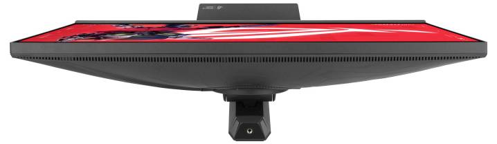 „Draufsicht auf einen Flachbildschirm-Monitor mit lebendiger roter Kunstwerk-Anzeige mit abstrakten Formen, montiert auf einem einzigen schwarzen Ständer."