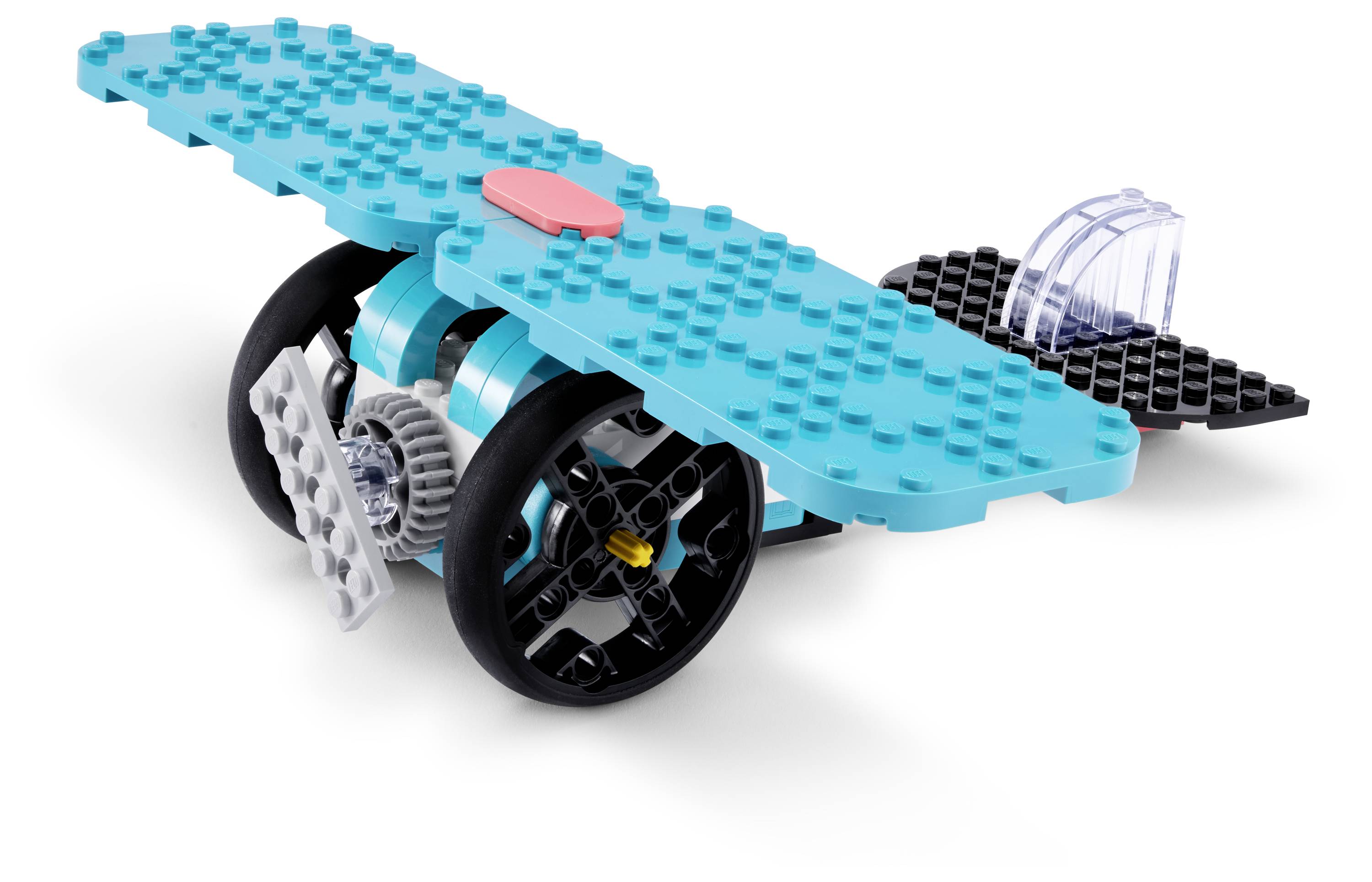 Ein Spielzeugflugzeug mit großen blauen Flügeln, schwarzen Rädern und einem durchsichtigen Heckbereich.