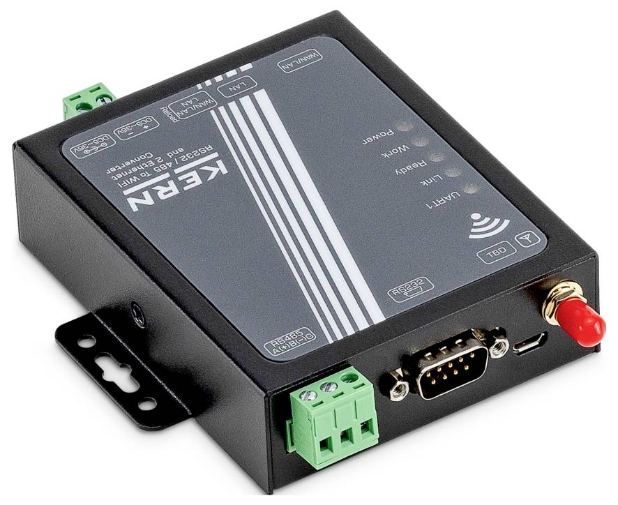 "Kern" markiertes elektronisches Gerät mit mehreren Anschlüssen und Steckverbindern, einschließlich eines seriellen Anschlusses und eines grünen Terminal-Blocks, auf einer ebenen Fläche.
