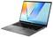 Ein silberner Laptop mit einem leuchtenden Bildschirm, auf dem bunte geometrische Formen und der Text „ASUS VivoBook" angezeigt werden.