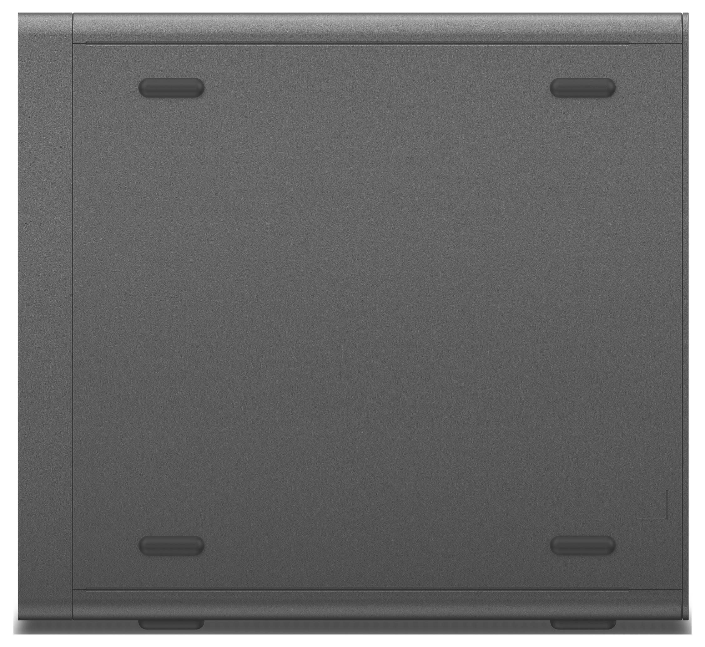 Ein dunkelgraues, quadratisches elektronisches Gerät, wahrscheinlich eine Spielkonsole, von oben fotografiert mit abgerundeten Ecken und kleinen Gummifüßen.