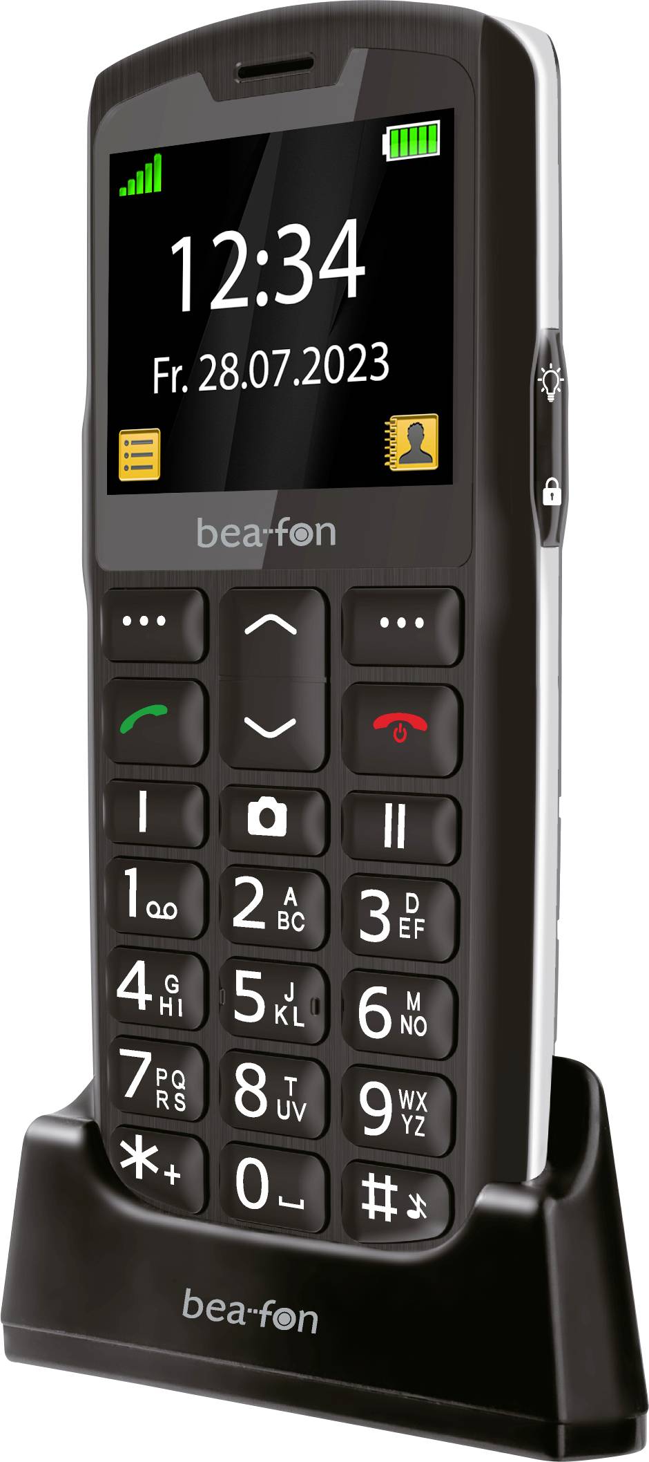 Mobiltelefon auf einer Ladestation mit großen, leicht ablesbaren Tasten. Der Bildschirm zeigt die Uhrzeit „12:34" und das Datum „Fr. 28.07.2023" an.