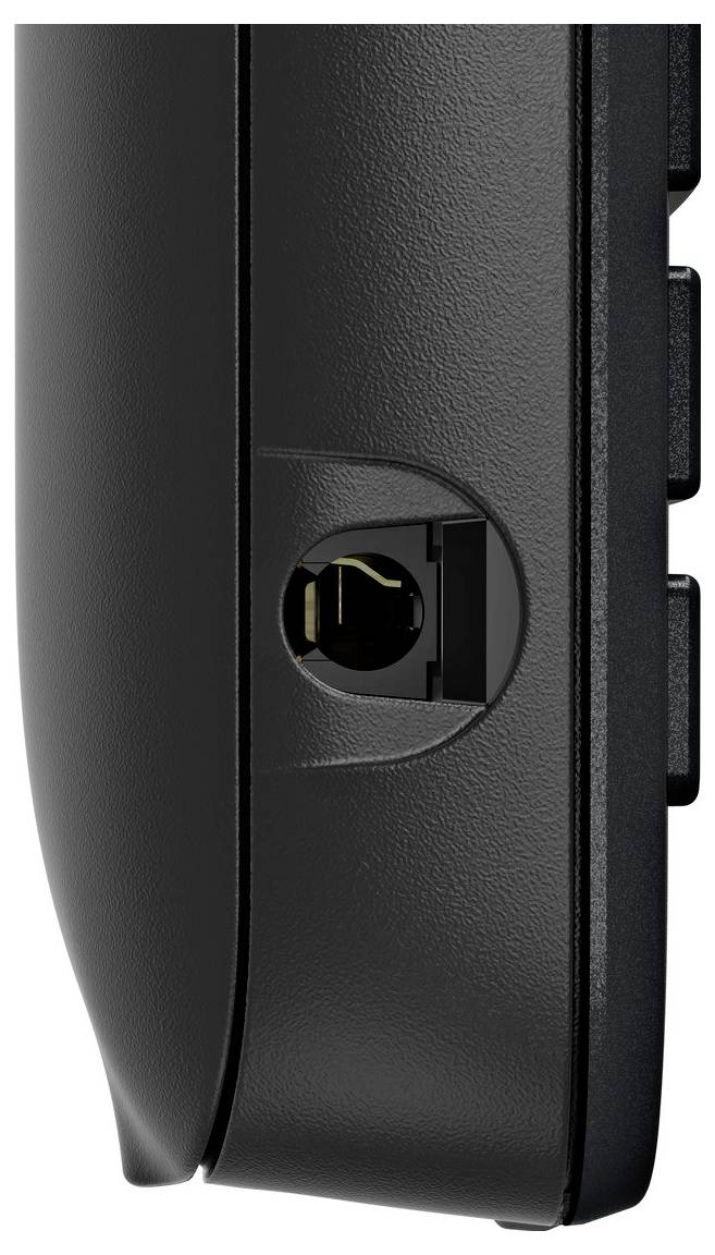 Eine Nahaufnahme eines schwarzen elektronischen Geräts, das auf der Seite einen kreisförmigen Anschluss zeigt, möglicherweise für eine Kabelverbindung oder zum Anschließen eines Zubehörs.