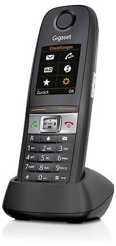 Ein schwarzes schnurloses Telefon mit einem Farbbildschirm, der Symbole und Text in deutscher Sprache anzeigt. Das Gerät ruht auf einer Ladestation.