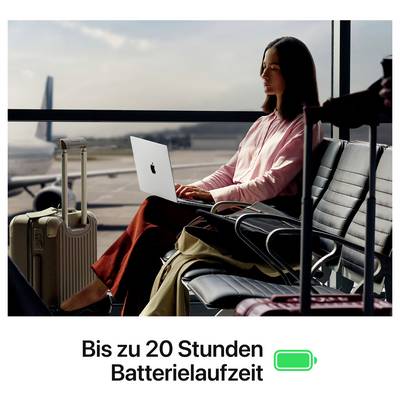 Eine Frau arbeitet an einem Laptop im Flughafen-Wartebereich. Text unten: 'Bis zu 20 Stunden Batterielaufzeit' mit Batterie-Symbol.