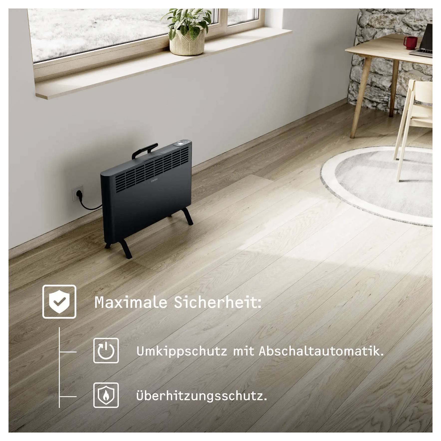 Ein kleiner schwarzer Elektroheizer auf einem Holzboden neben einem Fenster; Symbole und Text heben „Kippschutz" und „Überhitzungsschutz" hervor.