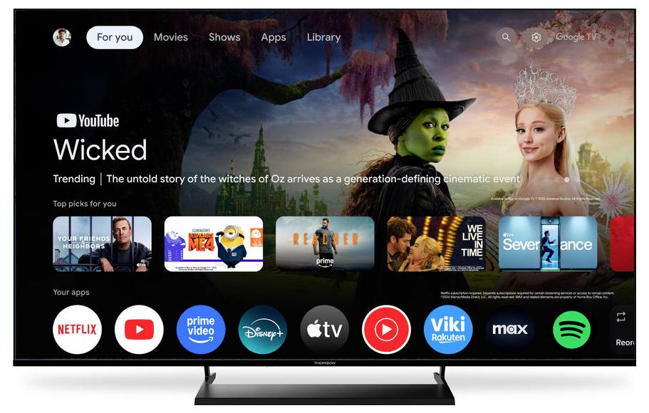 Smart-TV-Benutzeroberfläche mit Streaming-App-Symbolen und einem vorgestellten Film, „Wicked", mit Navigationsoptionen für Filme, Serien, Apps und Bibliothek.