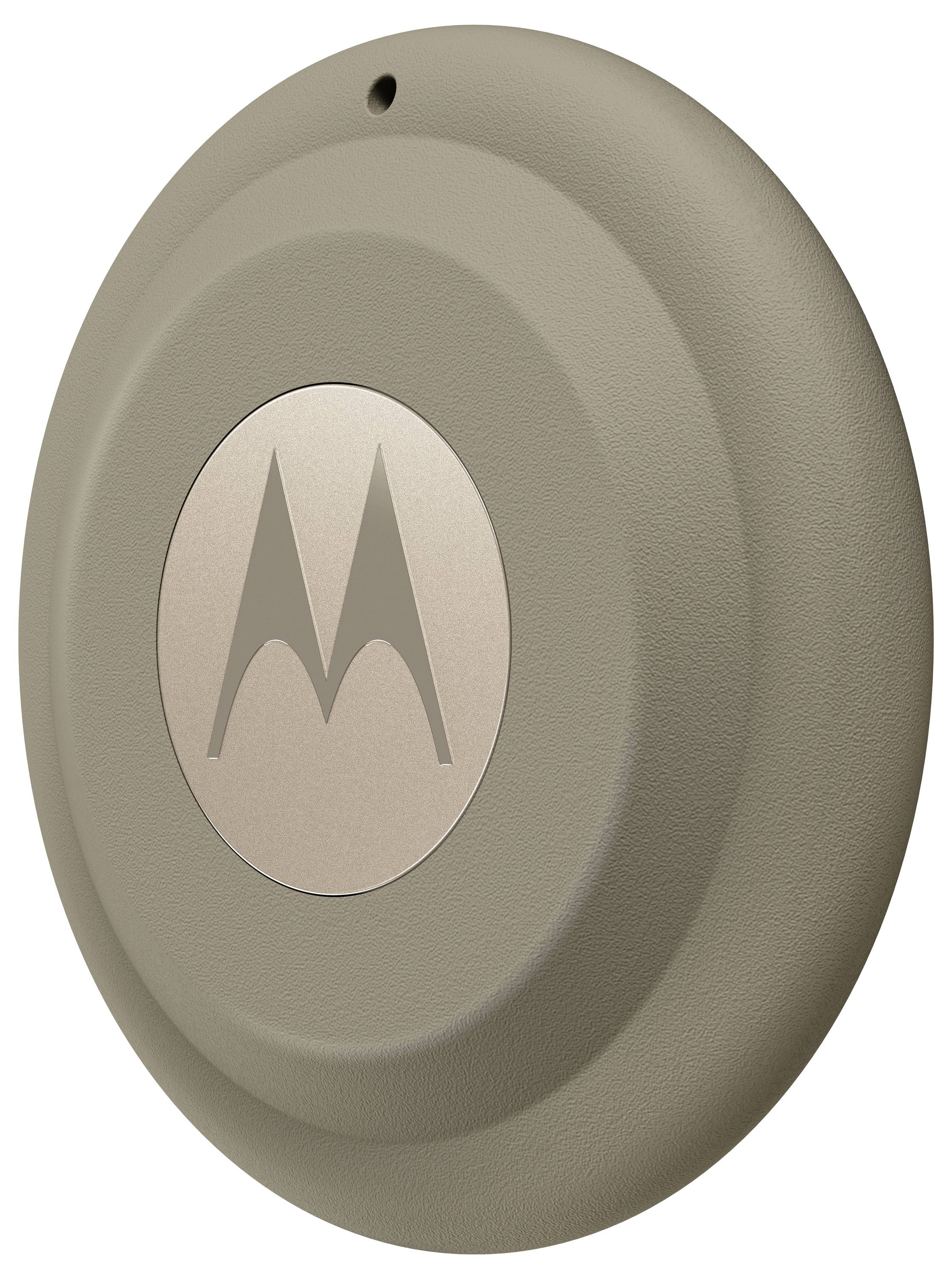 Ein rundes, beiges Motorola-Gerät mit einem zentralen Logo, das einer Scheibe oder einem Puck ähnelt, möglicherweise ein Tracker oder Sensor.