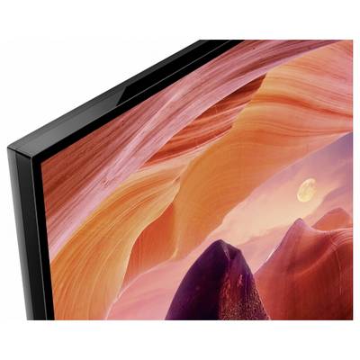 Nahaufnahme eines schwarzen Flachbildfernsehers, der eine lebendige rot-orangefarbene Canyonlandschaft-Hintergrund anzeigt.