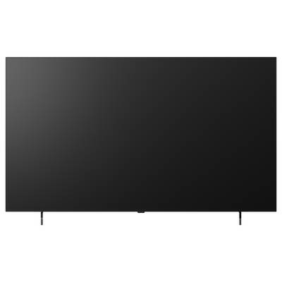 Großer leerer schwarzer Flachbildfernseher oder Monitor mit dünnem Rahmen auf zwei Beinen, frontal vor hellem Hintergrund gezeigt.