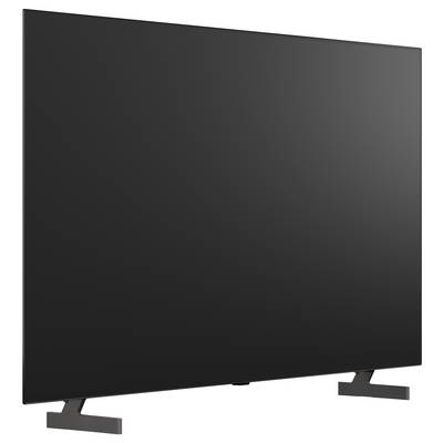 Ein großer Flachbildfernseher mit leerem schwarzen Bildschirm auf zwei abgewinkelten Standfüßen.
