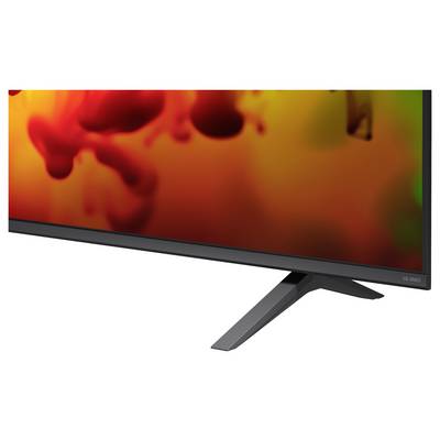 Ein LG C1 OLED-Flachbildfernseher auf einem Ständer, in einer Winkelansicht dargestellt, mit einem lebendigen rot-orange abstrakten Bild auf dem Bildschirm.