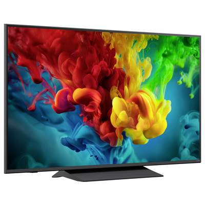 Flachbildfernseher, der bunte, wirbelnd wirbelnde Tinte oder Farbe in Rot, Gelb, Grün und Blau auf dunklem Hintergrund anzeigt.