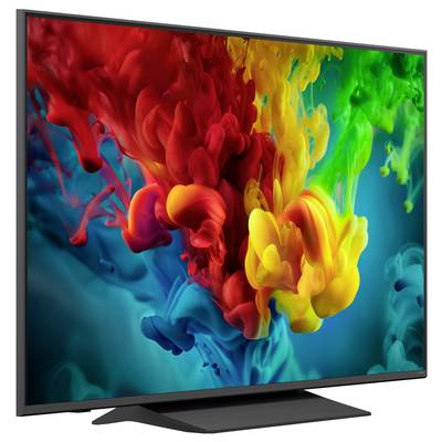 Flachbildfernseher zeigt helles abstraktes Spritzgemälde aus roter, gelber, grüner und blauer Farbe auf dunklem Hintergrund.