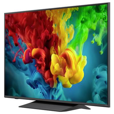 Ein Flachbildfernseher zeigt ein lebendiges abstraktes Spritzen aus roten, gelben, grünen und blauen Farbwolken auf dunklem Hintergrund.