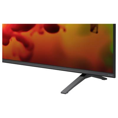 Teilansicht eines flachen LG-OLED-Fernsehers mit schwarzer Blende und Ständer, auf dem ein abstraktes rot-oranges Bild angezeigt wird.