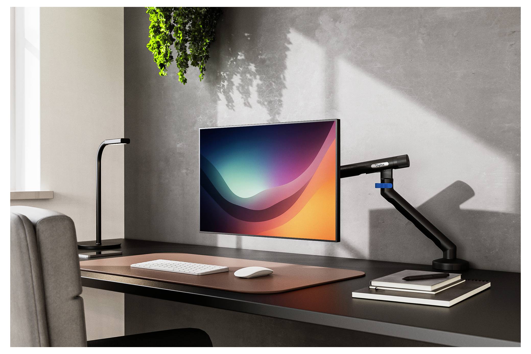 Moderner Schreibtisch mit einem Monitor, auf dem eine farbenfrohe abstrakte Tapete angezeigt wird, Tastatur, Maus, Schreibtischlampe, verstellbare Armleuchte und Bücher in der Nähe eines Fensters