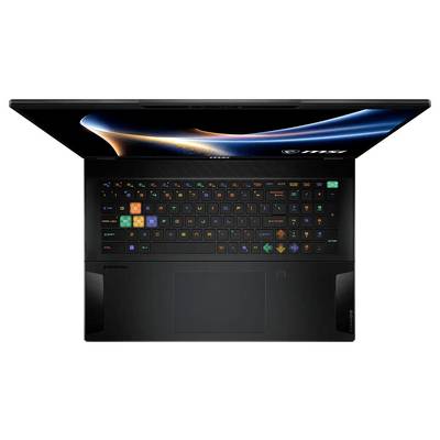 Draufsicht auf einen offenen MSI-Laptop mit beleuchter RGB-Tastatur und großem Touchpad auf weißem Hintergrund.