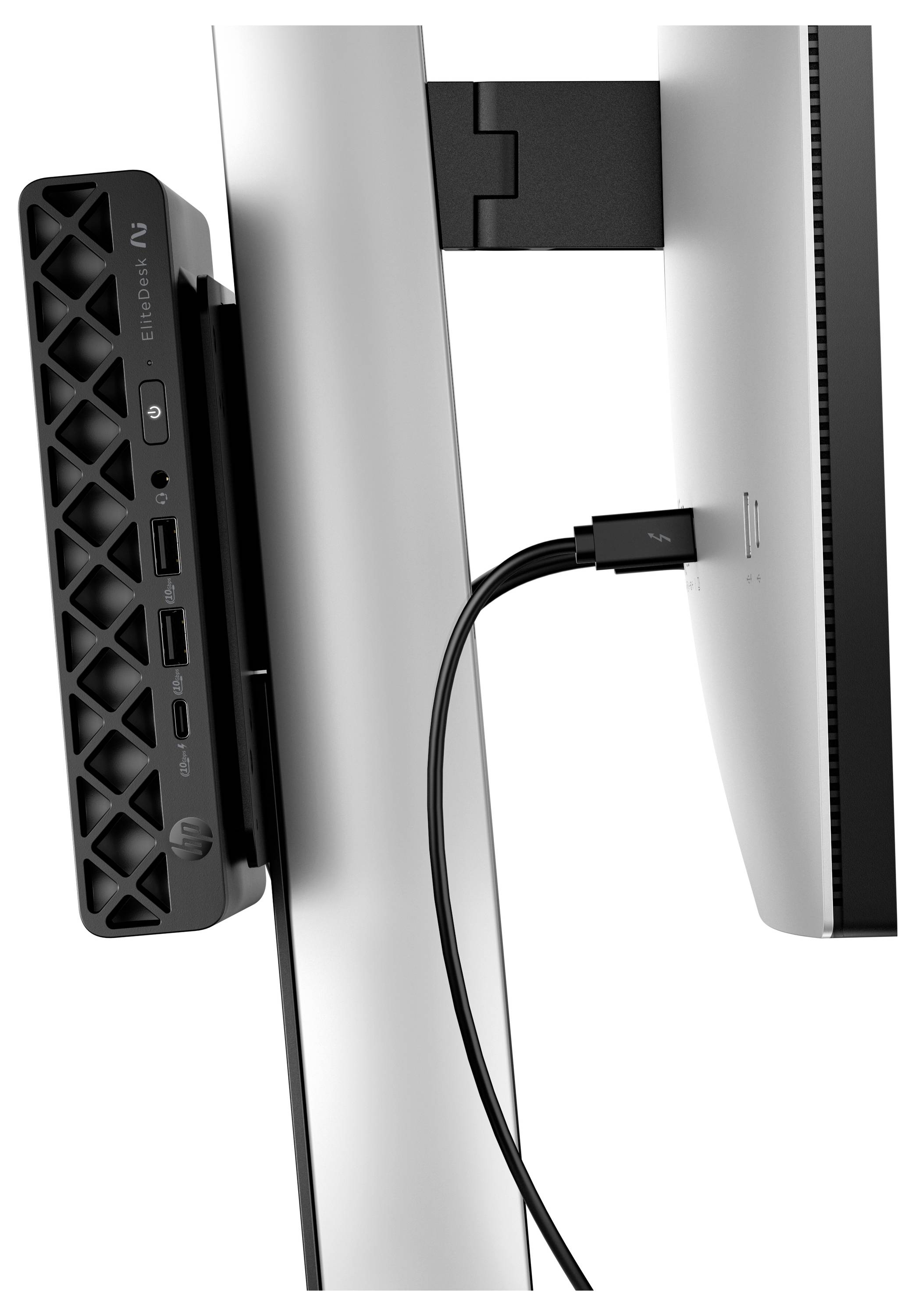 Seitenansicht eines HP-Desktop-Mini hinter einem Monitor montiert, mit einem Kabel, das zwischen dem Computer und dem Display verbunden ist.