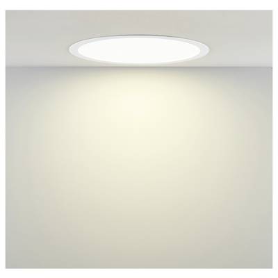 An der Decke montierte runde LED-Leuchte, die eine schlichte beigefarbene Wand beleuchtet.