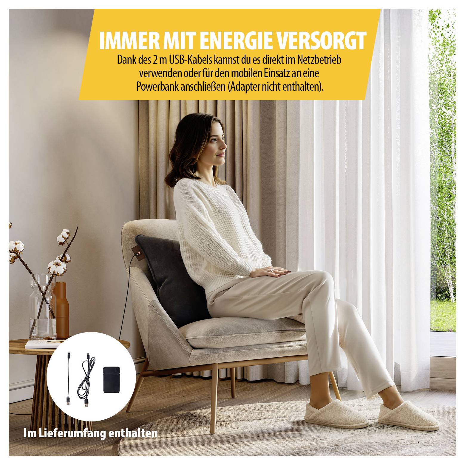 Werbebild einer Frau im Sessel mit Hinweis 'Immer mit Energie versorgt': USB-Kabel ermöglicht mobilen Betrieb per Powerbank, Adapter nicht enthalten.