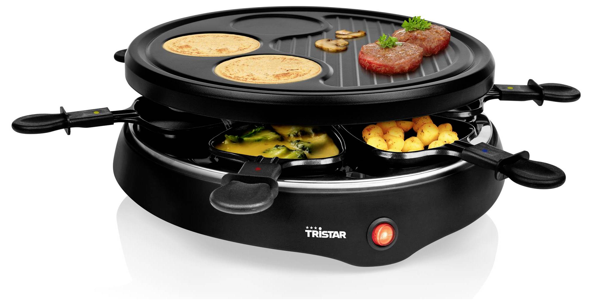 Schwarzer elektrischer Tischgrill mit zwei Garkammern, auf dem Pfannkuchen, Steak, Gemüse und Kartoffeln auf separaten Pfannen zu sehen sind.