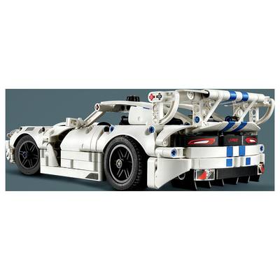 Rückansicht eines weißen LEGO-ähnlichen Rennwagens mit freiliegentem, blau akzentuiertem Hinterrahmen, großen Rädern und "V10"-Rückleuchten-Branding.