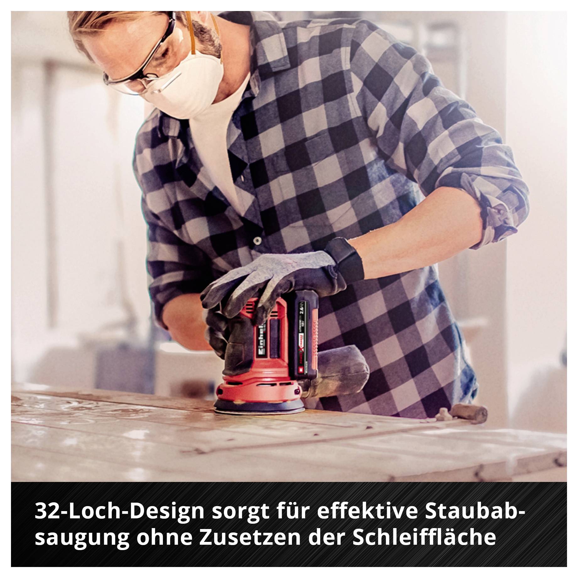 Mann mit Schutzbrille und Atemmaske schleift Holz mit einem roten Exzenterschleifer; Text: '32-Loch-Design sorgt für effektive Staubabsaugung ohne Zusetzen der Schleiffläche'<br>