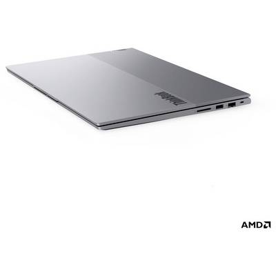 Silberner Lenovo-Laptop in geschlossenem Zustand auf weißem Hintergrund, im Winkel positioniert, um sein dünnes Profil und die seitlichen Anschlüsse zu zeigen, mit AMD-Logo in der Ecke.