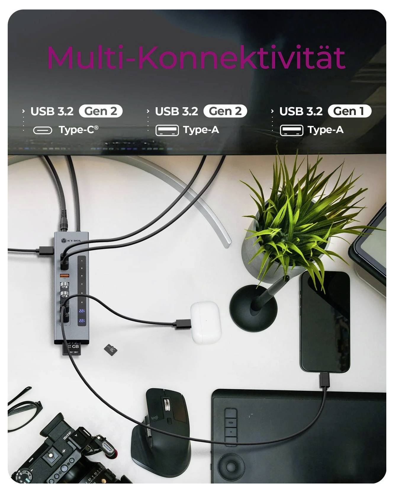 Draufsicht eines Schreibtischs mit einer USB-C-Dockingstation mit der Bezeichnung „Multi-Konnektivität", die einen Laptop, ein Telefon, eine Maus, eine Kamera und Peripheriegeräte über USB 3.2 Gen 1/2-Anschlüsse verbindet.