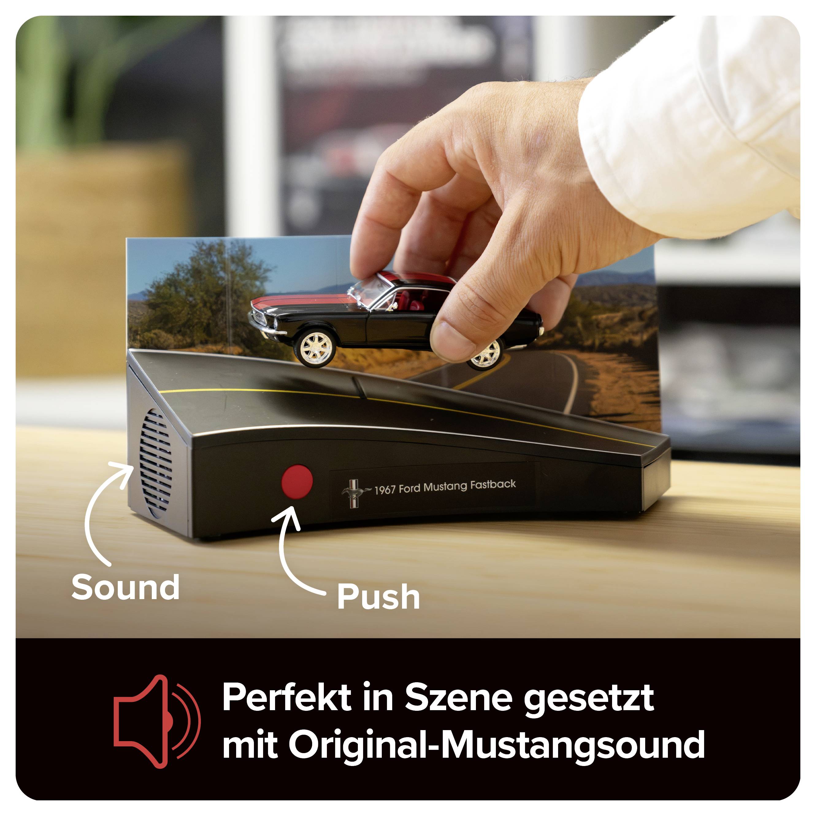 Hand drückt ein Modellauto auf eine Soundbasis; Beschriftung: 'Push' und 'Sound'. Werbebild für einen 1967 Ford Mustang Fastback mit Original-Mustangsound.