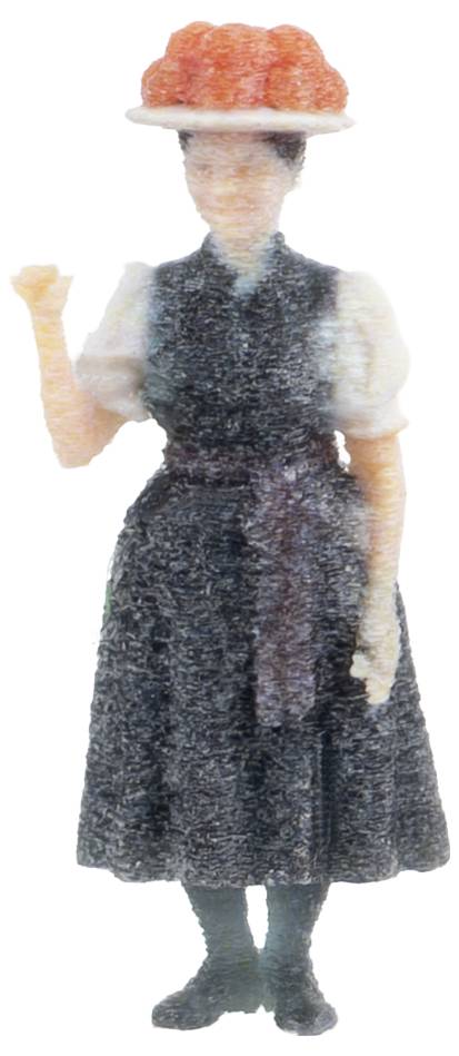 Eine kleine Figurine einer Frau in einem dunklen Kleid und weißem Hemd, die einen roten Hut trägt und einen Arm hochhält.