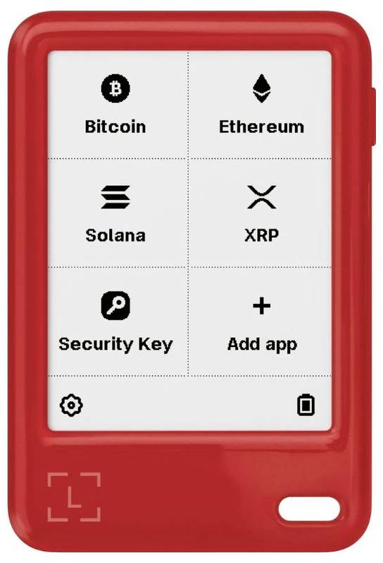 Bildschirm des roten Hardware-Kryptowallet mit einem Raster von App-Optionen: Bitcoin, Ethereum, Solana, XRP, Security Key und App hinzufügen.
