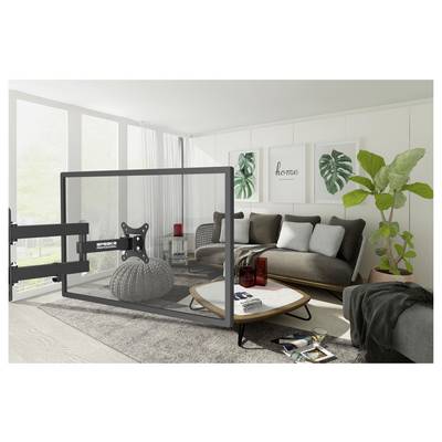 Modernes Wohnzimmer mit grauem Sofa, rundem Couchtisch, gerahmter Wandkunst, großer Pflanze und einer TV-Wandhalterung im Vordergrund.