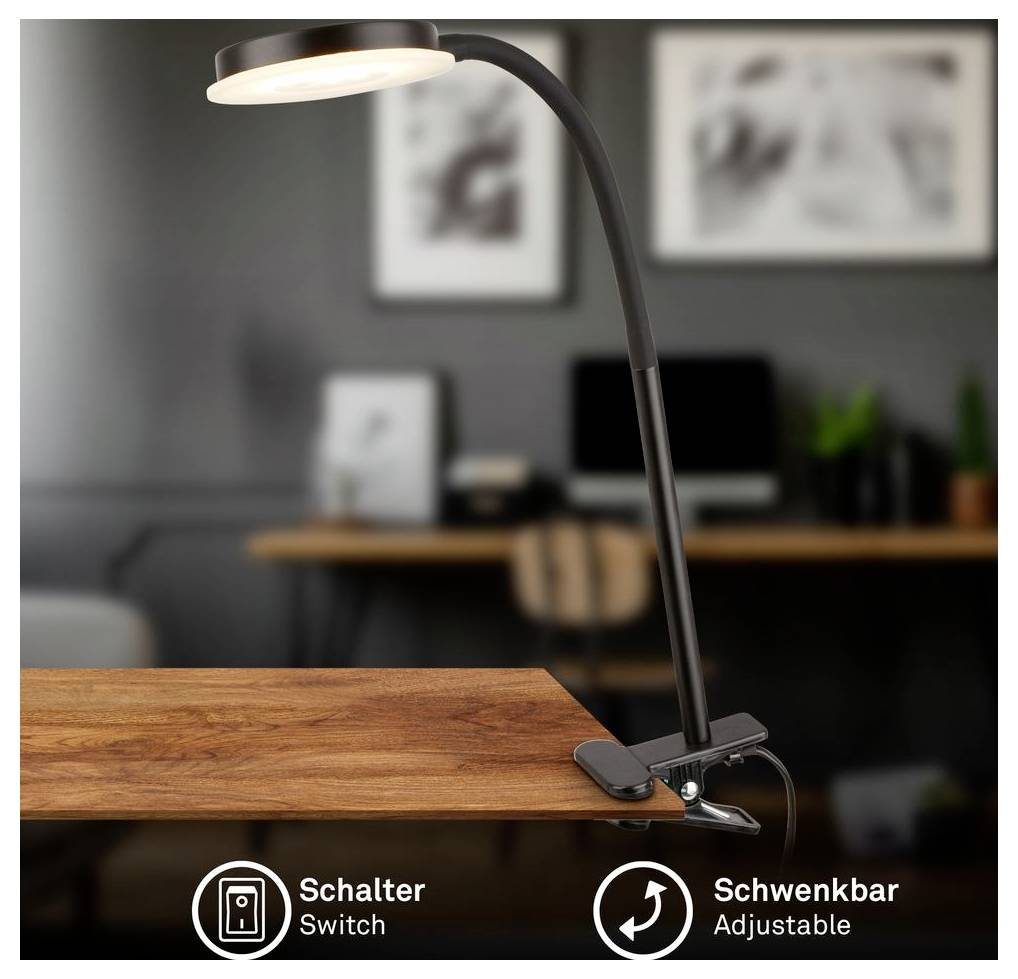 Schwarze Klemmleuchte mit verstellbarem Arm und Beschriftungen "Schalter/Schalter" und "Schwenkbar/Schwenkbar" in einer Homeoffice-Umgebung.