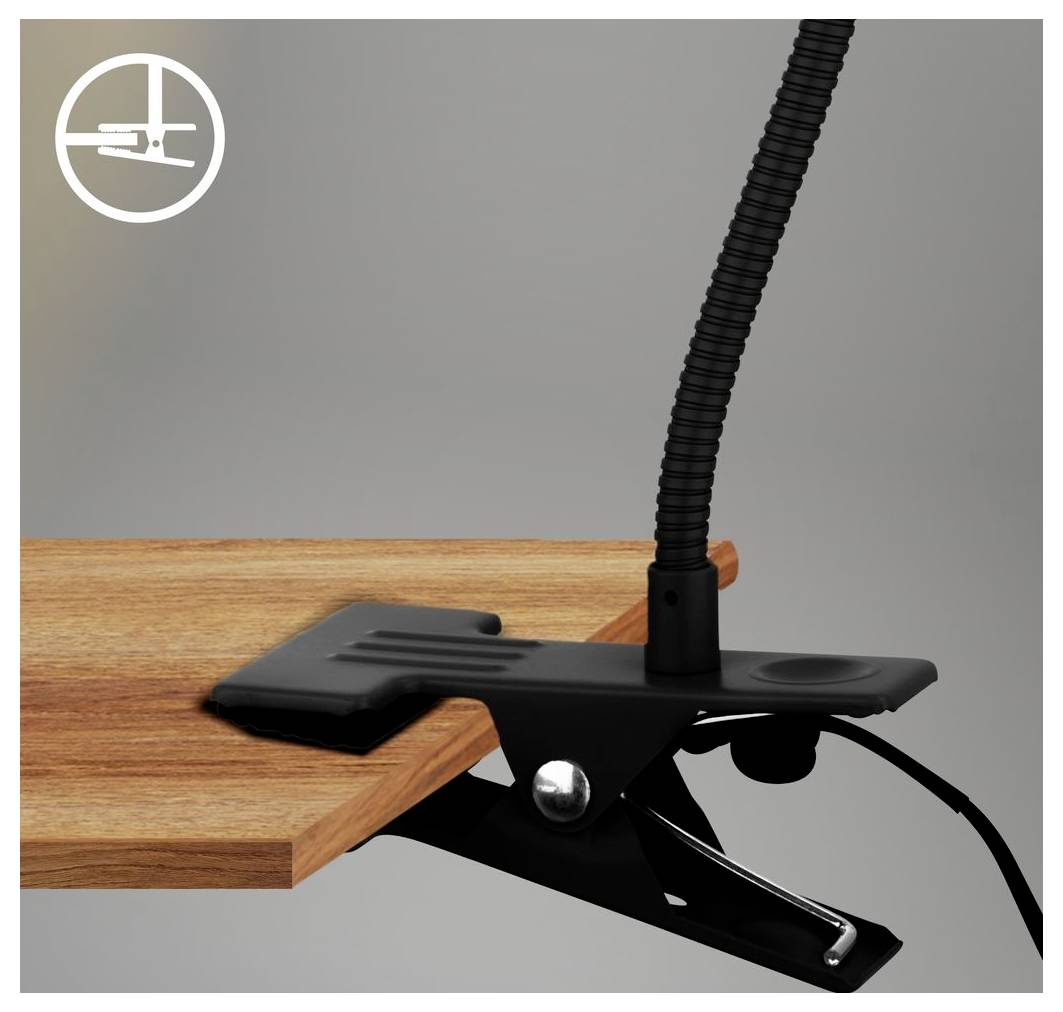Schwarze Klemmleuchte, die an der Kante eines Holzschreibtisches befestigt ist, mit einem flexiblen Schwanenhals-Arm, der sich gegen einen grauen Hintergrund nach oben erstreckt.