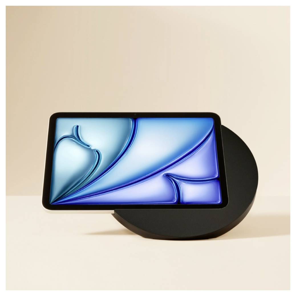 Ein modernes Smartphone-Display mit einem blauen abstrakten Hintergrundbild, das auf einem schwarzen kreisförmigen Ständer gegen einen beigen Hintergrund ruht.