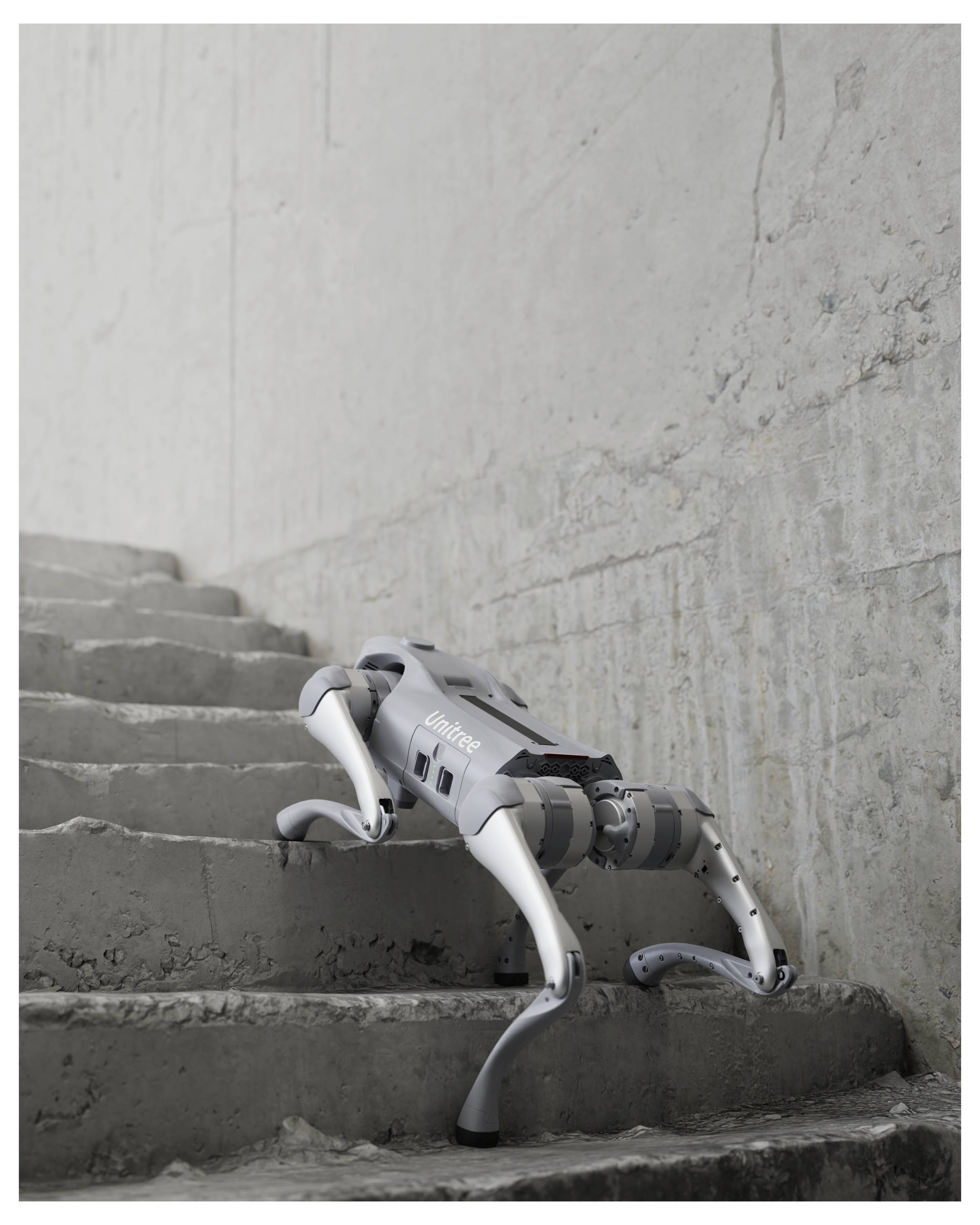 Vierbeiniger Roboter klettert Betontreppen in einem unfertigen Treppenhaus mit rauen grauen Wänden.