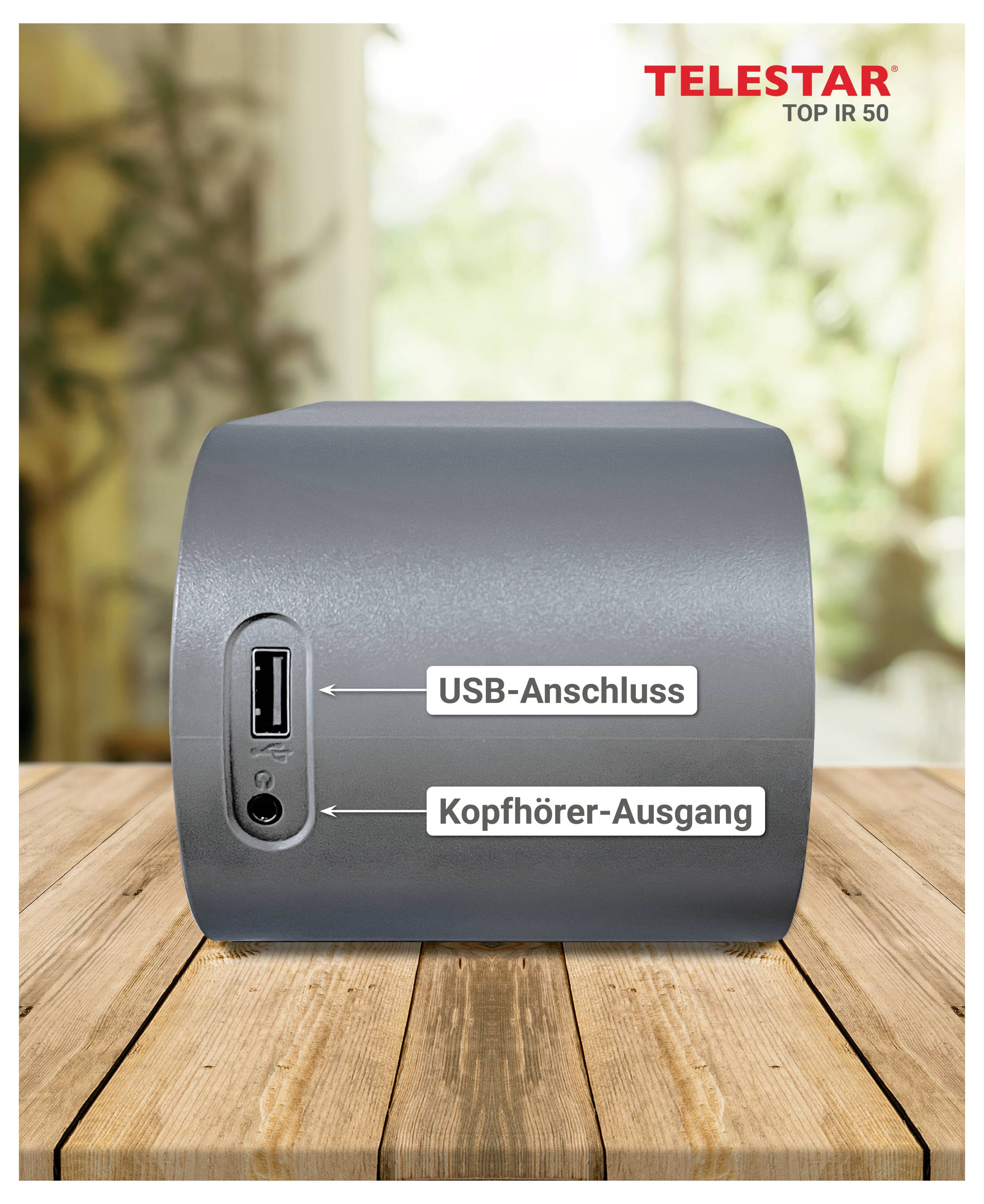 Graues Lautsprechergerät auf einem Holztisch, mit beschrifteten Anschlüssen für „USB-Anschluss" und „Kopfhörer-Ausgang"; TELESAR TOP IR 50 Logo in der oberen rechten Ecke.